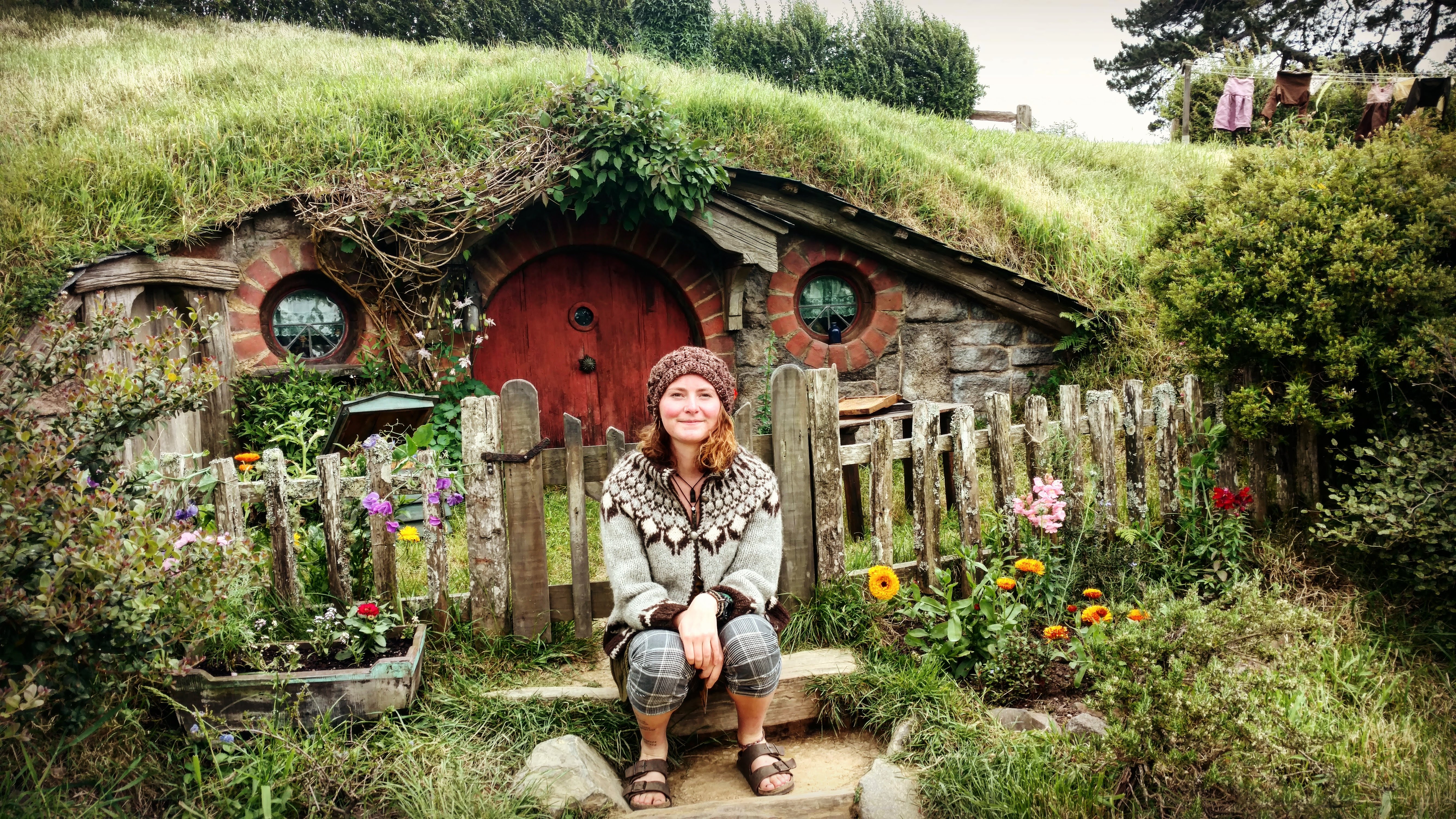Photo of Nissa outside the hobbit hole in the Shire in NZ